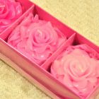 Candles roses blossoms in decorative strongbox pink