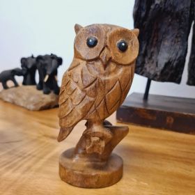 Figure wood owl sitting on branch small